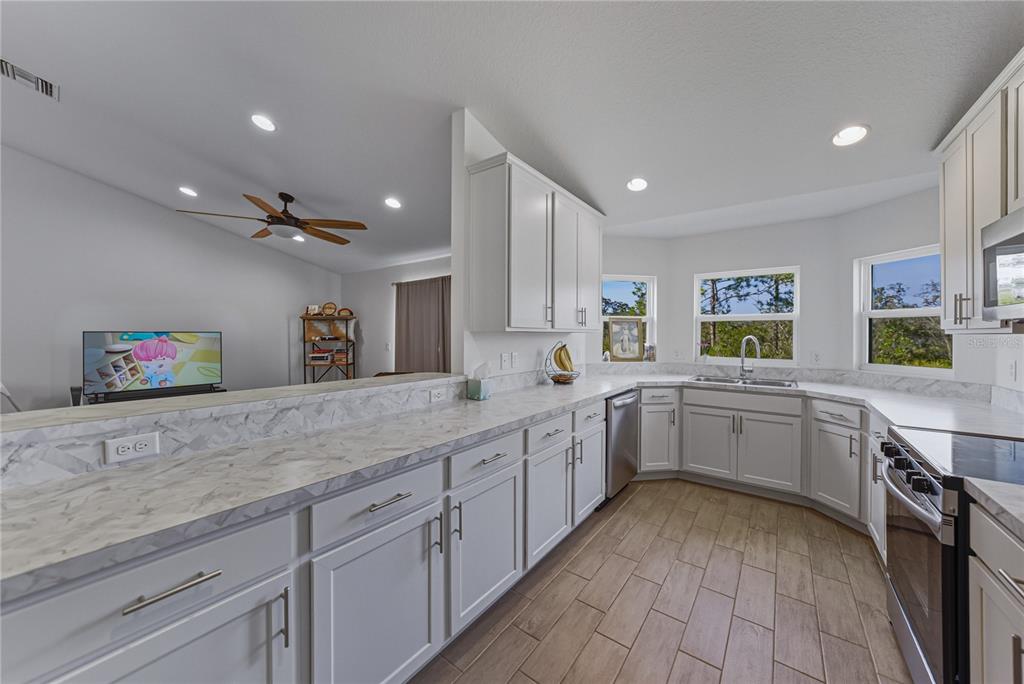 4514 Adrienne Street Sebring, FL 33872 - Photo 26 of 55 a kitchen with sink and cabinets