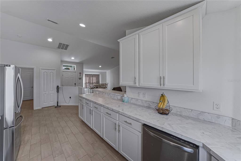 4514 Adrienne Street Sebring, FL 33872 - Photo 27 of 55 a kitchen with stainless steel appliances granite countertop a sink a refrigerator and a granite counter tops