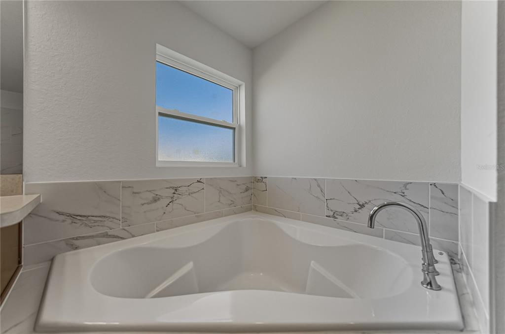 4514 Adrienne Street Sebring, FL 33872 - Photo 37 of 55 a white bath tub sitting in a bathroom