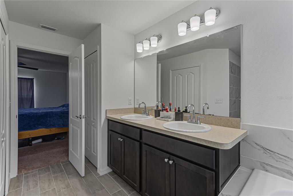 4514 Adrienne Street Sebring, FL 33872 - Photo 38 of 55 a bathroom with a sink double vanity and a mirror