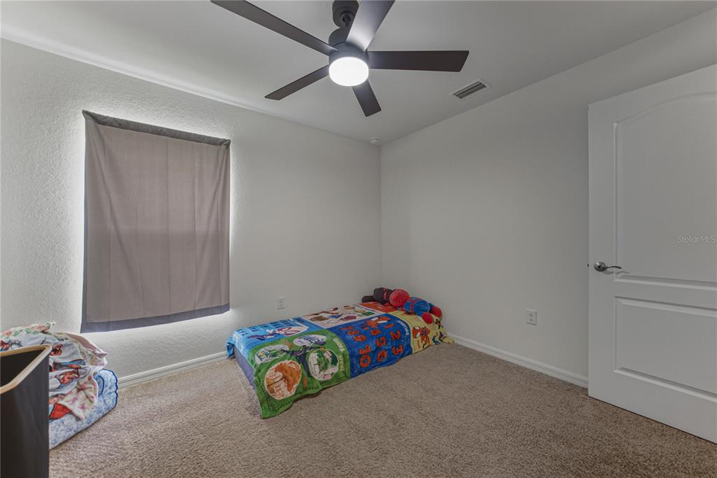 4514 Adrienne Street Sebring, FL 33872 - Photo 41 of 55 a bedroom with bed and a chandelier fan