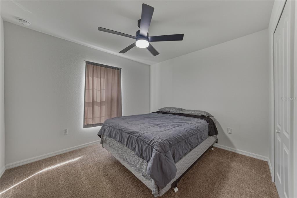 4514 Adrienne Street Sebring, FL 33872 - Photo 44 of 55 a bed sitting in a bedroom next to a window