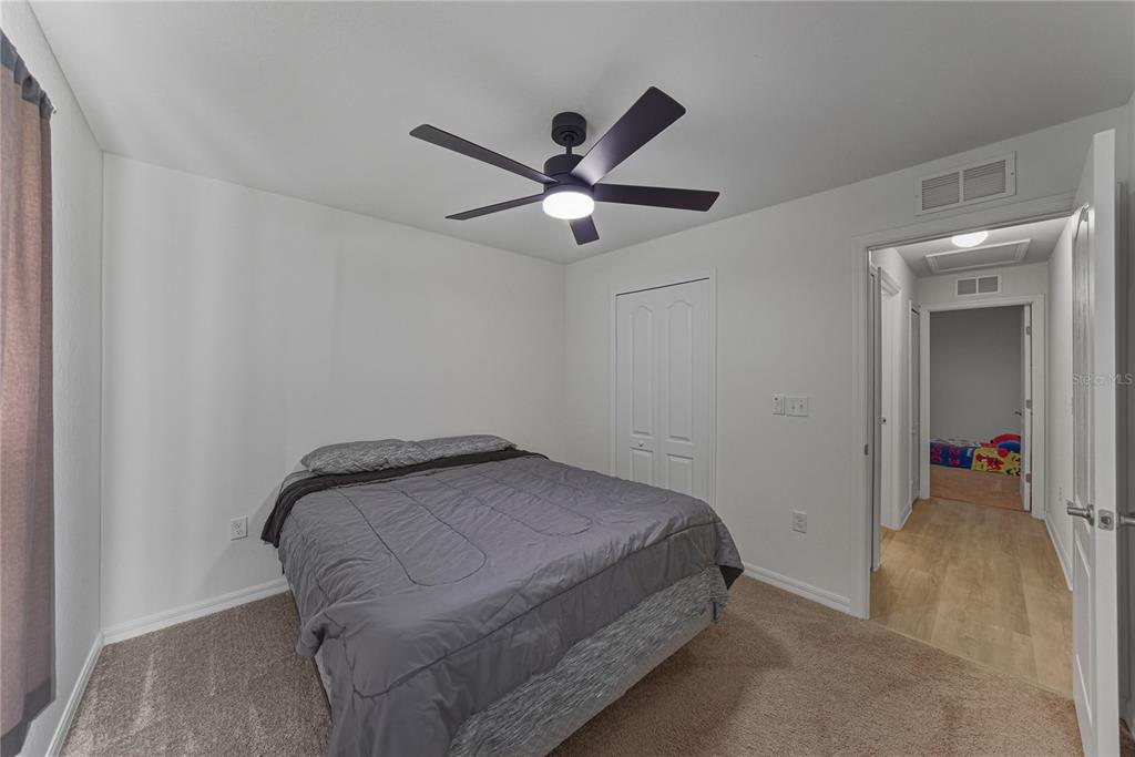 4514 Adrienne Street Sebring, FL 33872 - Photo 45 of 55 a bedroom with a bed and a ceiling fan