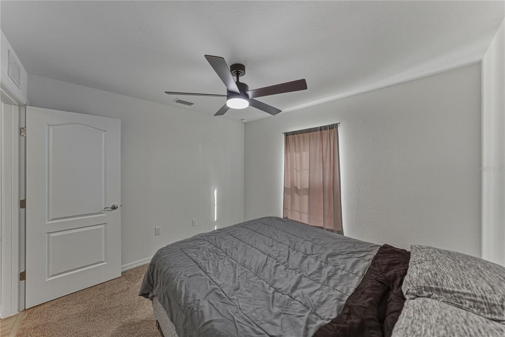 4514 Adrienne Street Sebring, FL 33872 - Photo 46 of 55 a bedroom with a bed and a ceiling fan