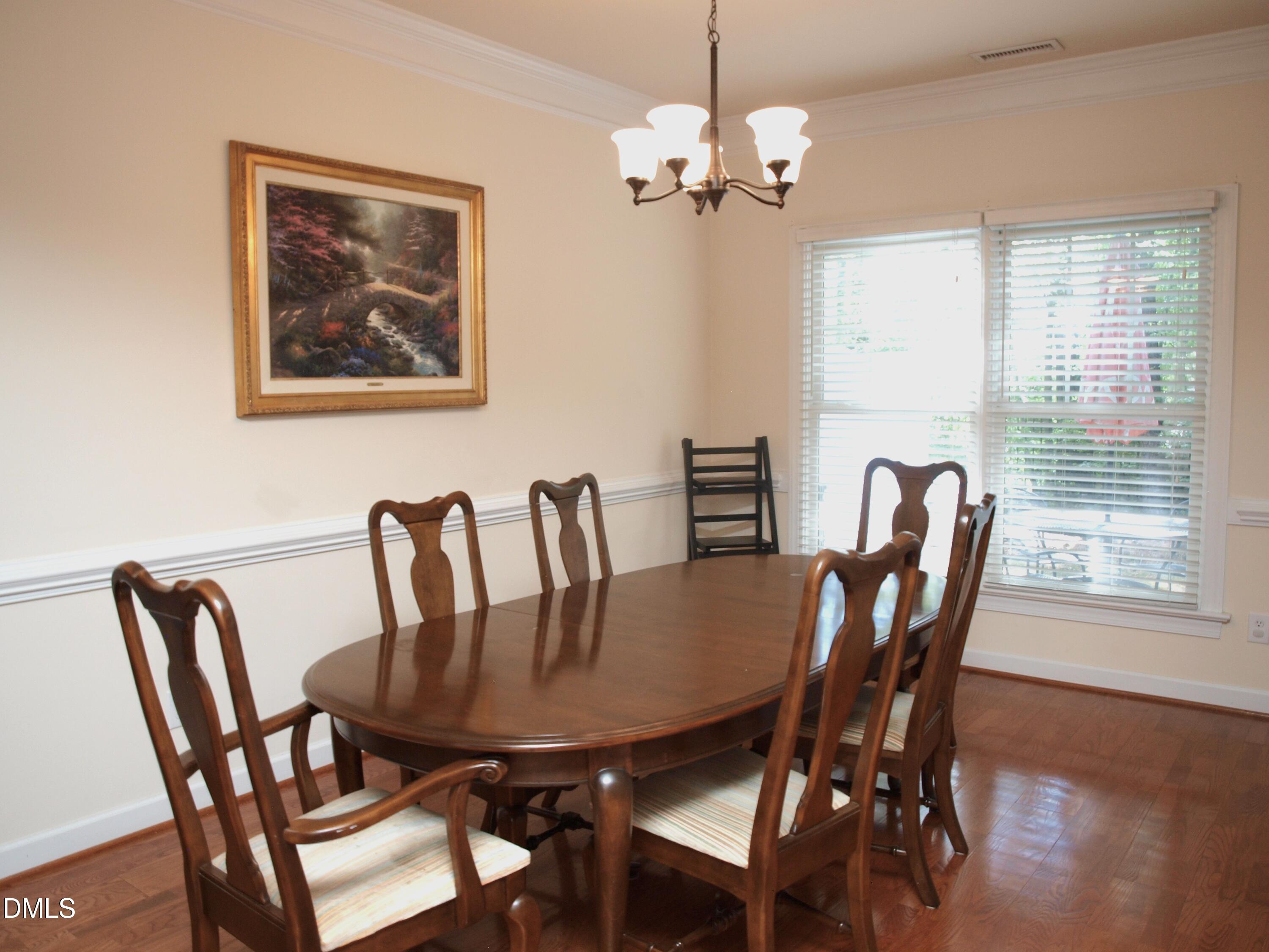 5206 Rio Grande Drive Raleigh, NC 27616 - Photo 14 of 37 a view of a dining room with furniture window and wooden floor