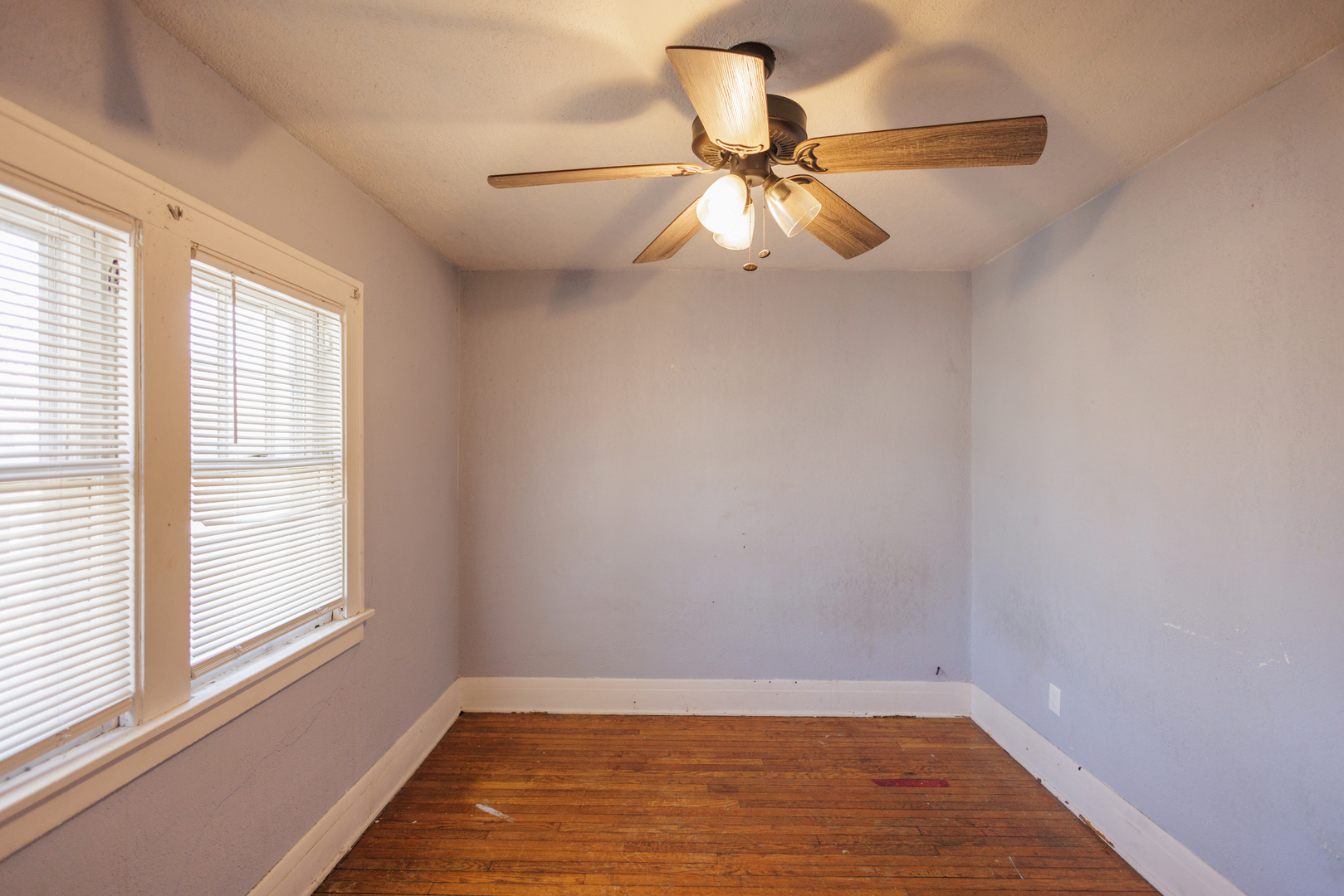 378 South Evergreen Avenue Kankakee, IL 60901 - Photo 16 of 26 a view of an empty room with wooden floor and a window