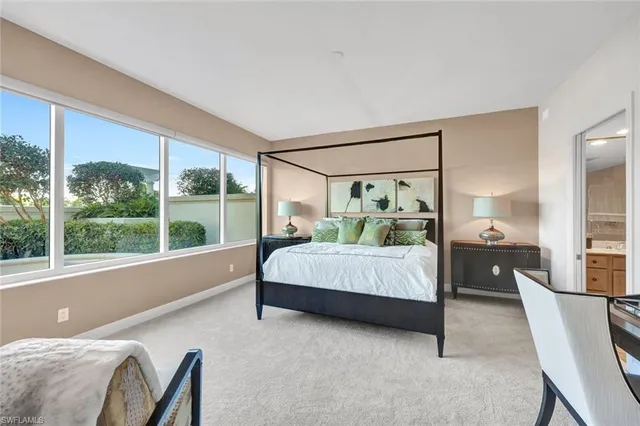 a bedroom with a bed and large window