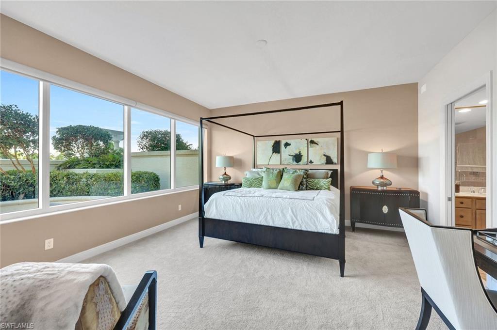 265 Indies Way, Unit T1 Naples, FL 34110 - Photo 4 of 13 a bedroom with a bed and large window