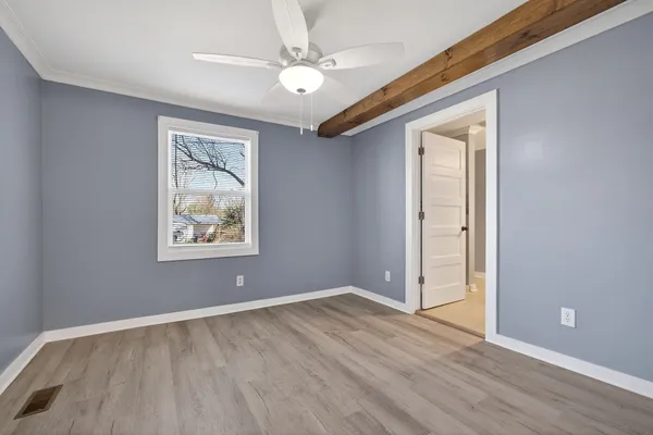 wooden floor in an empty room with a window