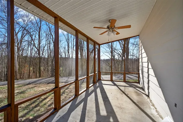 a view of a balcony with wooden floor and furniture