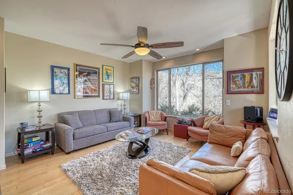 a living room with furniture a large window and a flat screen tv