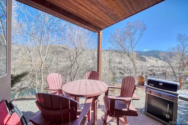 a outdoor dining room with furniture and wooden floor