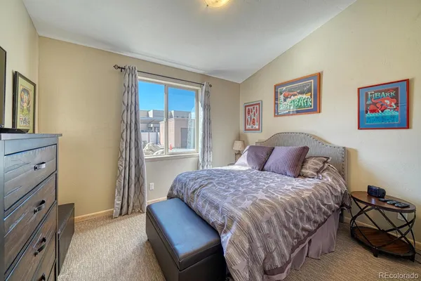 a bedroom with a bed and cabinet