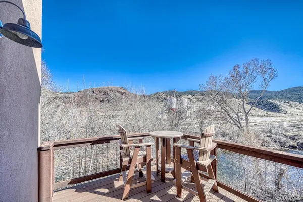 a view of a balcony with furniture and mountain view