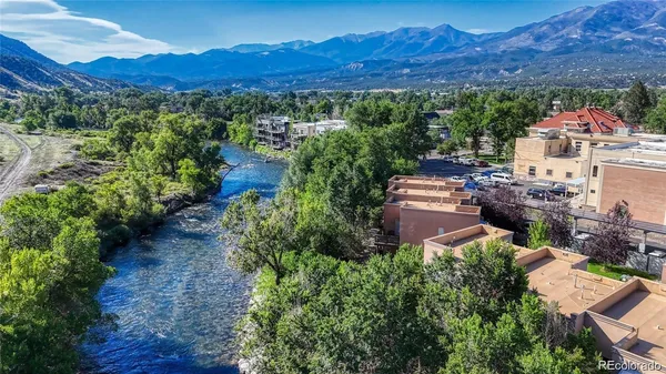 a view of a lush green hillside and houses