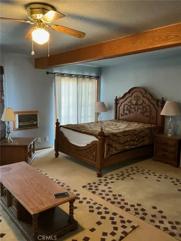 a bedroom with a bed a lamp and window