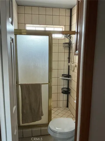 a bathroom with a toilet and a shower
