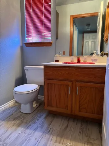 a bathroom with a toilet a sink and mirror
