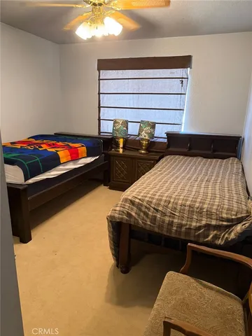 a bed sitting in a bedroom next to a window