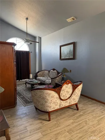 a very nice looking room with wooden floor and furniture