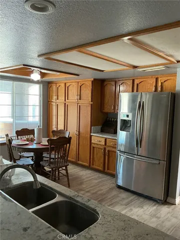 a kitchen with a table chairs and refrigerator
