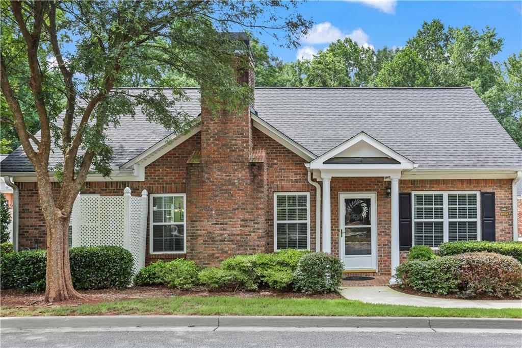 3319 Raes Creek Road Marietta, GA 30008 - Photo 1 of 1 a view of a white house next to a yard