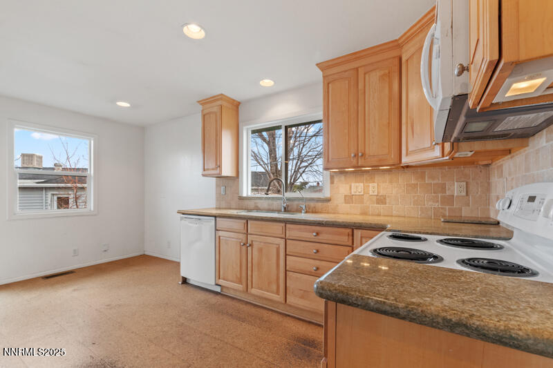 1606 Knoll Drive Reno, NV 89509 - Photo 12 of 30 a kitchen that has a sink a stove and a wooden cabinets
