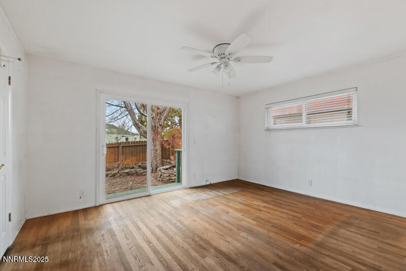 1606 Knoll Drive Reno, NV 89509 - Photo 17 of 30 a view of an empty room with a window and wooden floor