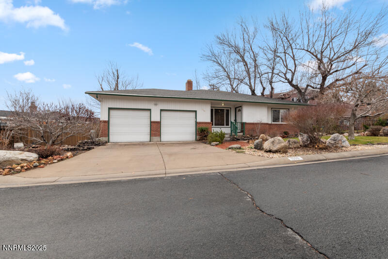1606 Knoll Drive Reno, NV 89509 - Photo 3 of 30 a front view of a house with a yard and garage