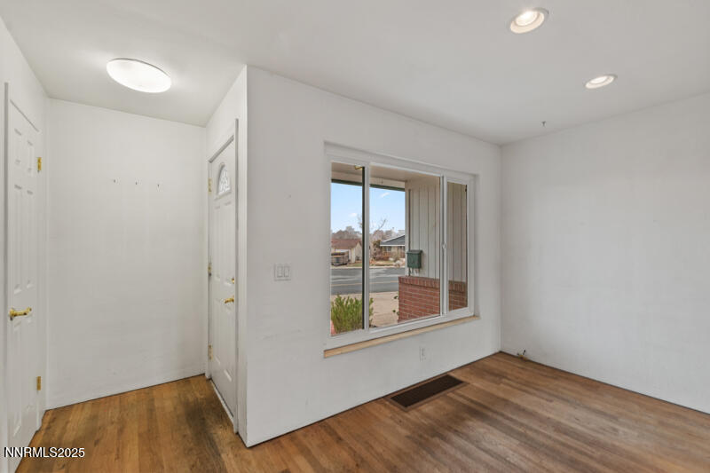 1606 Knoll Drive Reno, NV 89509 - Photo 5 of 30 a view of an empty room with wooden floor and a window