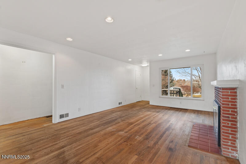 1606 Knoll Drive Reno, NV 89509 - Photo 7 of 30 a view of an empty room with wooden floor and a window