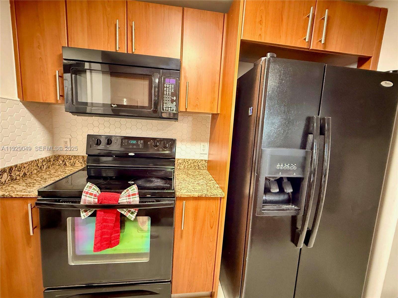 2701 Southwest 3rd Avenue, Unit 202 Miami, FL 33129 - Photo 13 of 32 a kitchen with stainless steel appliances granite countertop a refrigerator and a microwave