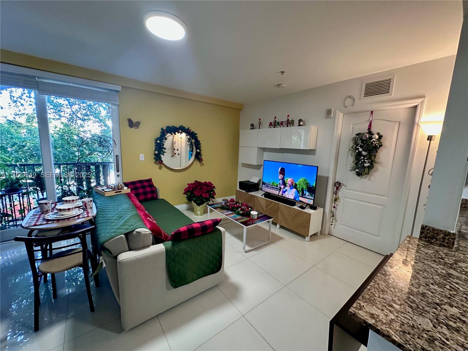 2701 Southwest 3rd Avenue, Unit 202 Miami, FL 33129 - Photo 20 of 32 a living room with furniture and a flat screen tv