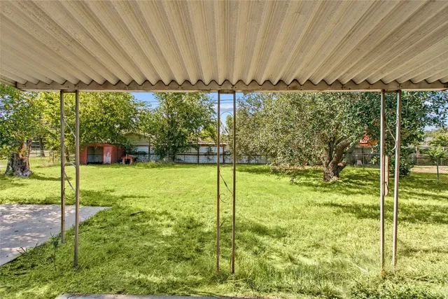 a backyard of a house with a garden and plants