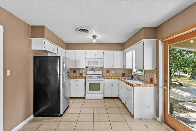 a kitchen with a refrigerator a sink and dishwasher