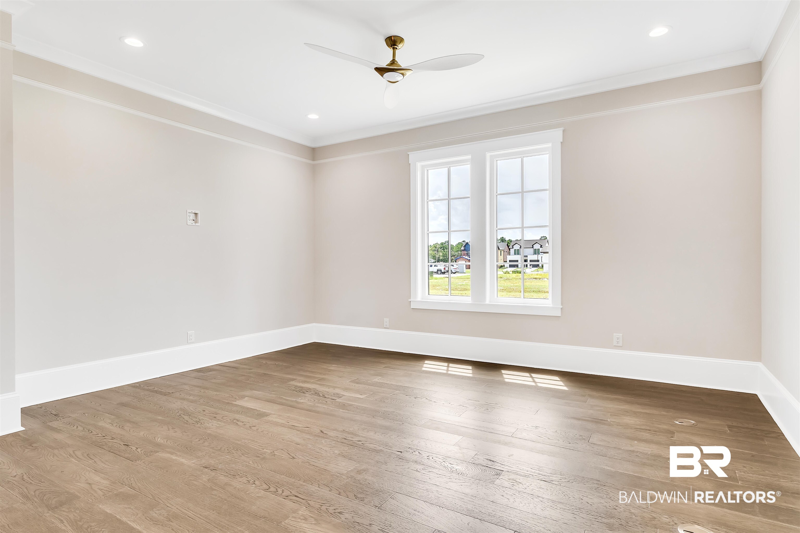 829 Inlet Circle Gulf Shores, AL 36542 - Photo 7 of 31 Empty room with light wood-type flooring, crown molding, and ceiling fan