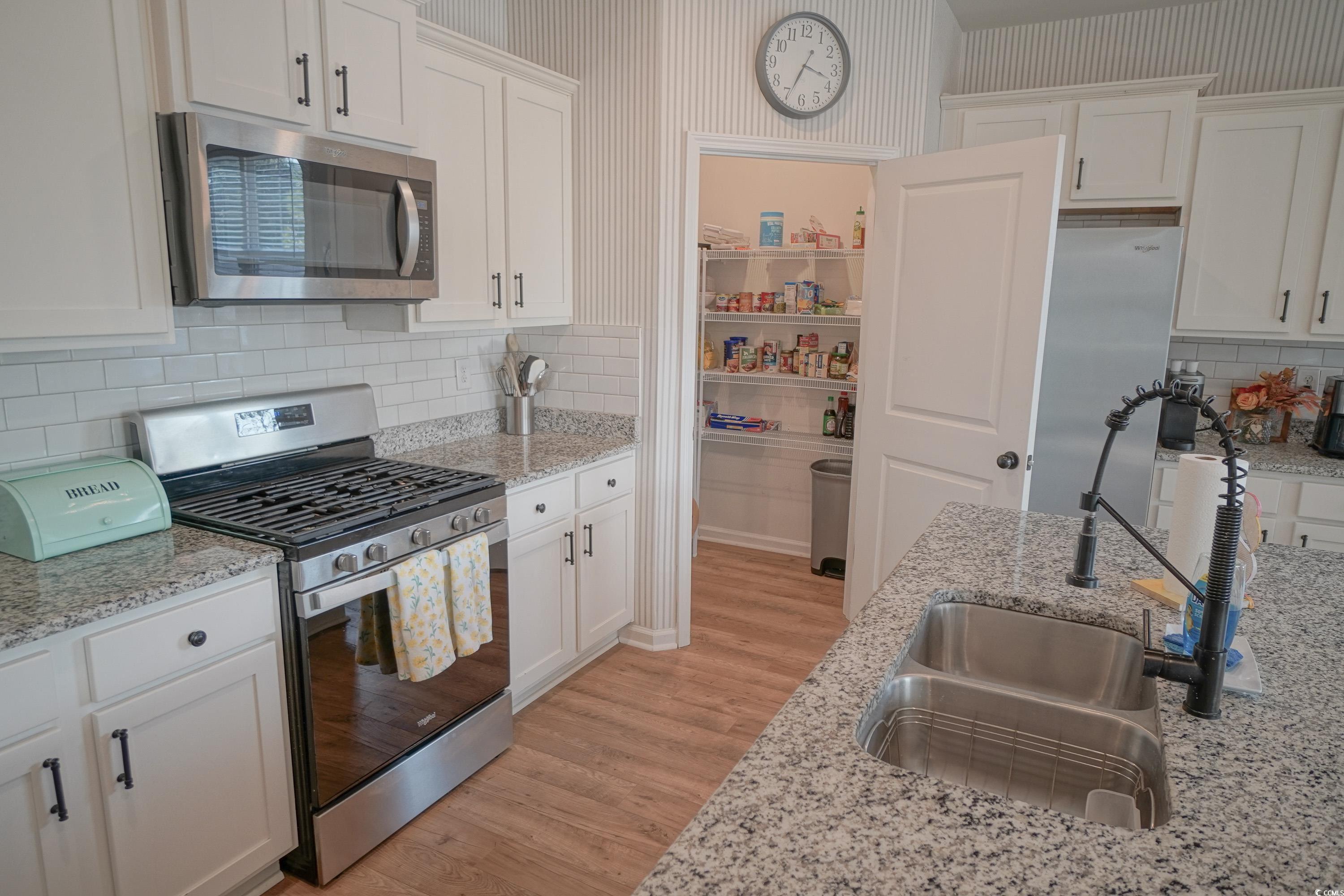 240 Pin Oak Drive Murrells Inlet, SC 29576 - Photo 13 of 40 Kitchen with light stone counters, light hardwood