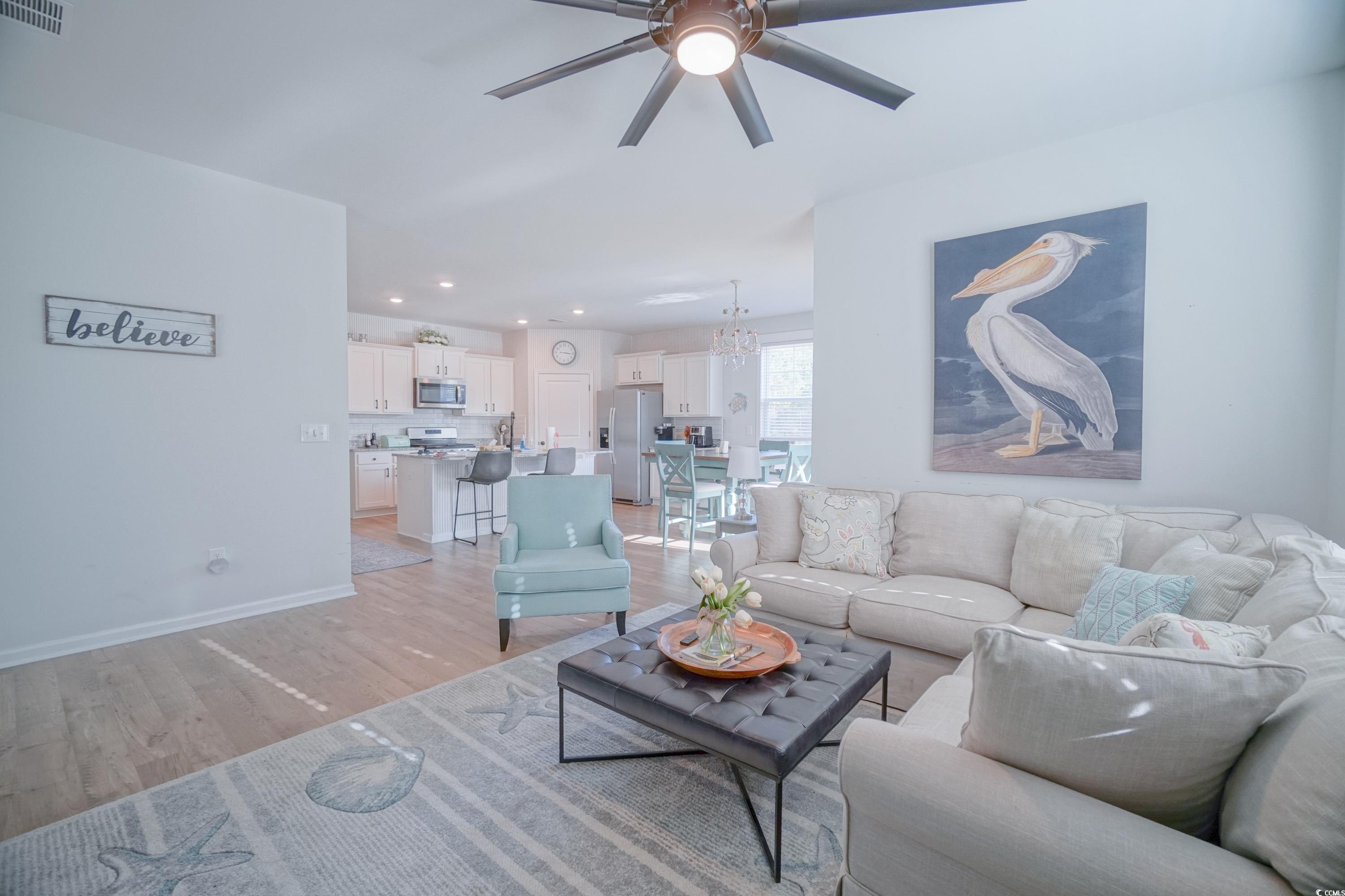 240 Pin Oak Drive Murrells Inlet, SC 29576 - Photo 5 of 40 Living room with ceiling fan with notable chandeli