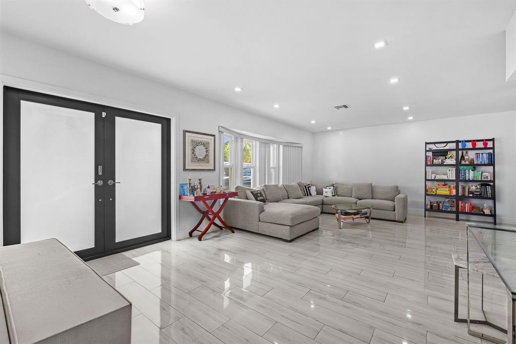 a living room with furniture and book shelf