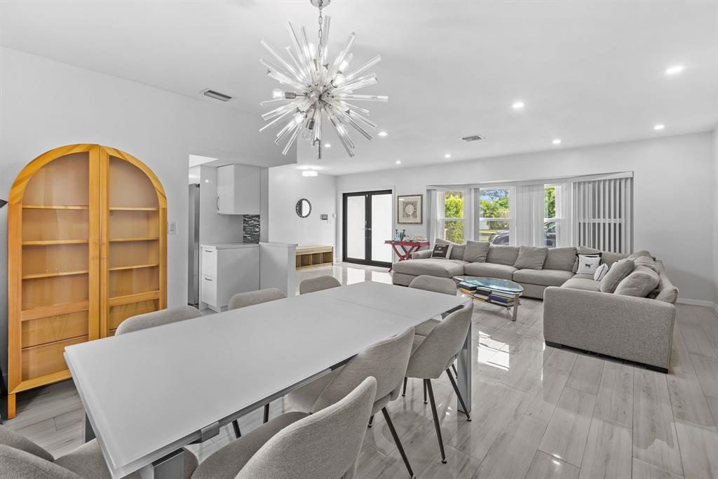 3500 North 46th Avenue Hollywood, FL 33021 - Photo 5 of 13 a living room with furniture a chandelier and a large window