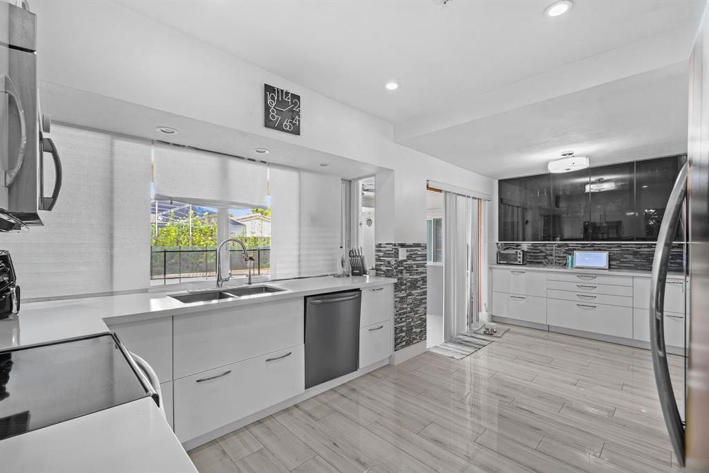 3500 North 46th Avenue Hollywood, FL 33021 - Photo 8 of 13 a kitchen with stainless steel appliances kitchen island granite countertop a sink and cabinets