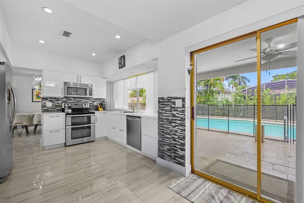 3500 North 46th Avenue Hollywood, FL 33021 - Photo 9 of 13 a kitchen with a refrigerator and a stove top oven