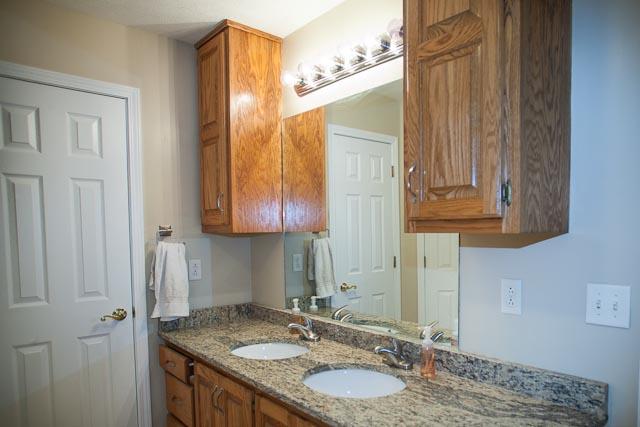 4086 Trinity Road Franklin, TN 37067 - Photo 16 of 20 a bathroom with a granite countertop sink and a mirror