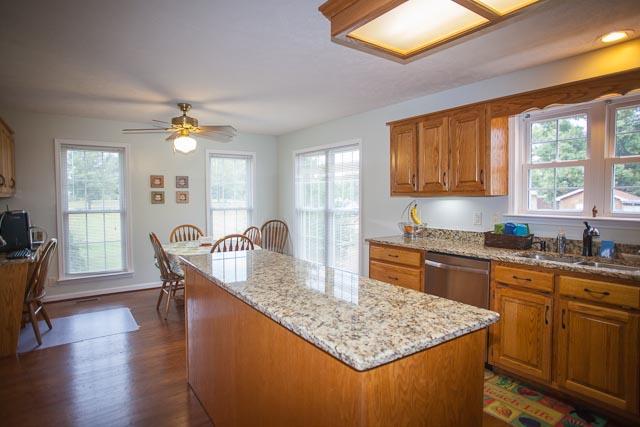 4086 Trinity Road Franklin, TN 37067 - Photo 7 of 20 a kitchen with granite countertop a sink a counter top space and living room