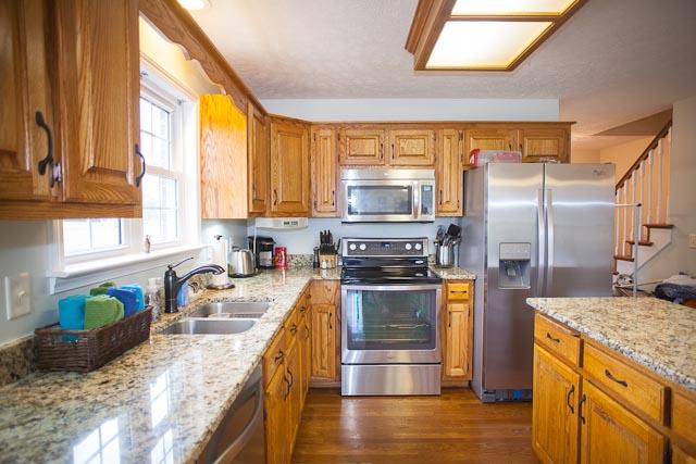 4086 Trinity Road Franklin, TN 37067 - Photo 8 of 20 a kitchen with stainless steel appliances granite countertop a sink a stove and a refrigerator