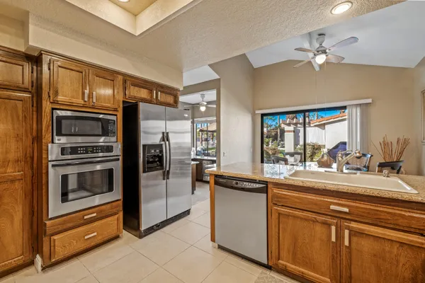 a kitchen with stainless steel appliances granite countertop a sink and cabinets
