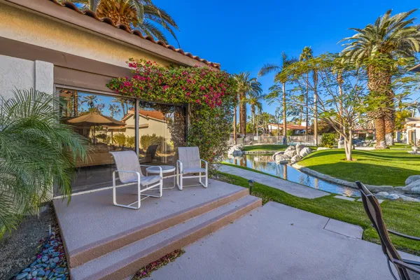 a view of a table and chairs under an umbrella