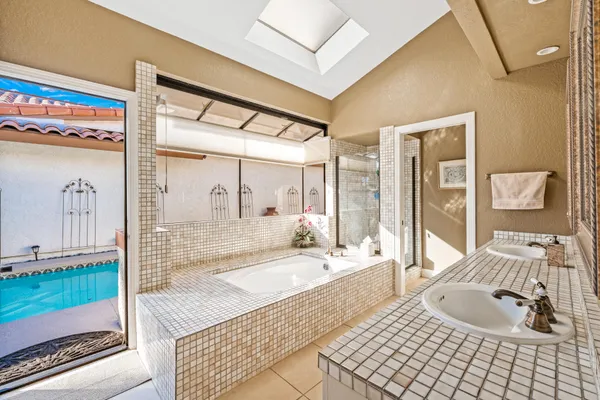 a view of a swimming pool with a patio and a garden