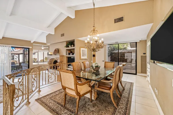 a view of a dining room with furniture and a chandelier