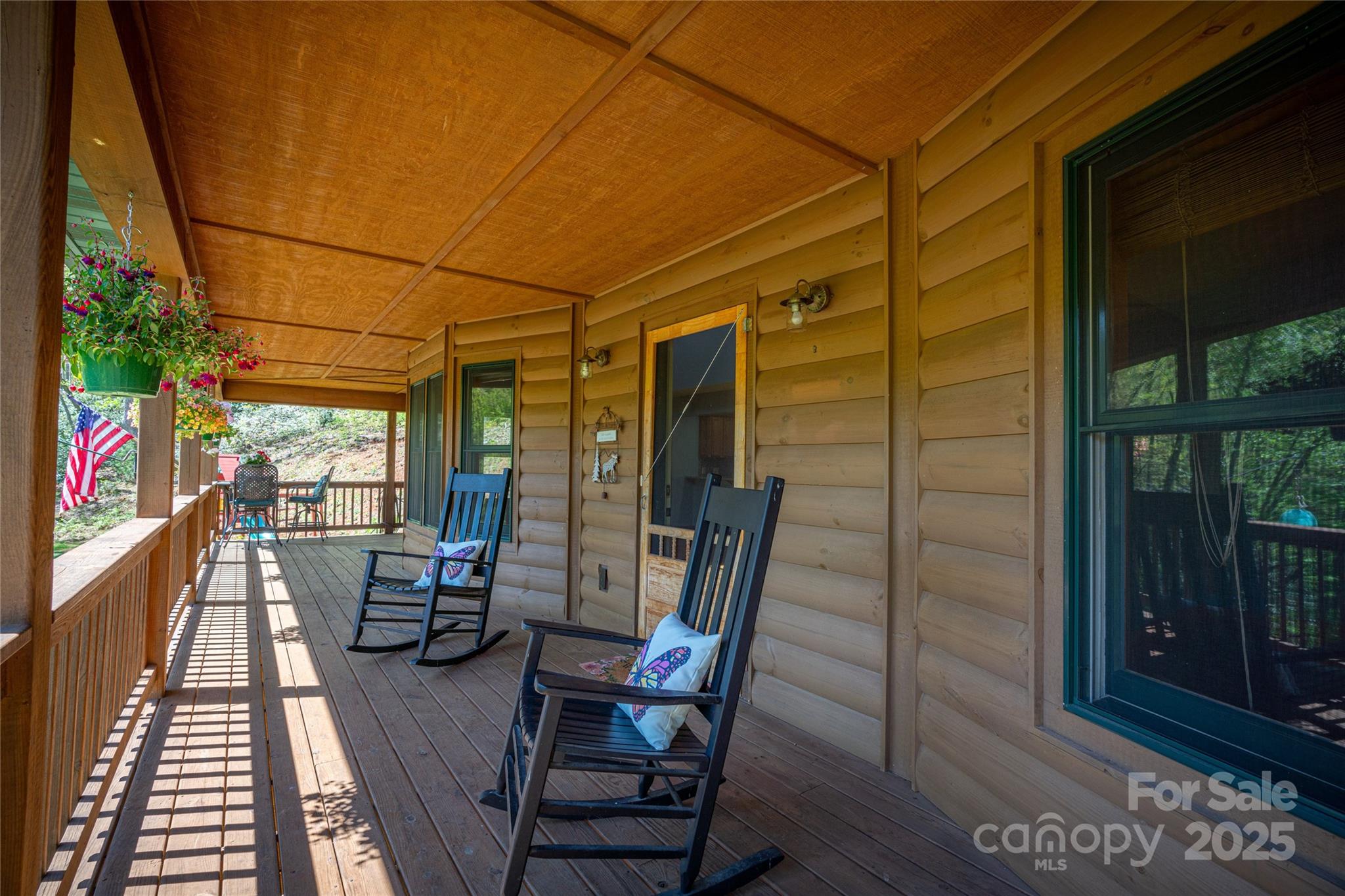 234 Deer Run Road Canton, NC 28716 - Photo 11 of 48 a view of a balcony with chairs and wooden floor